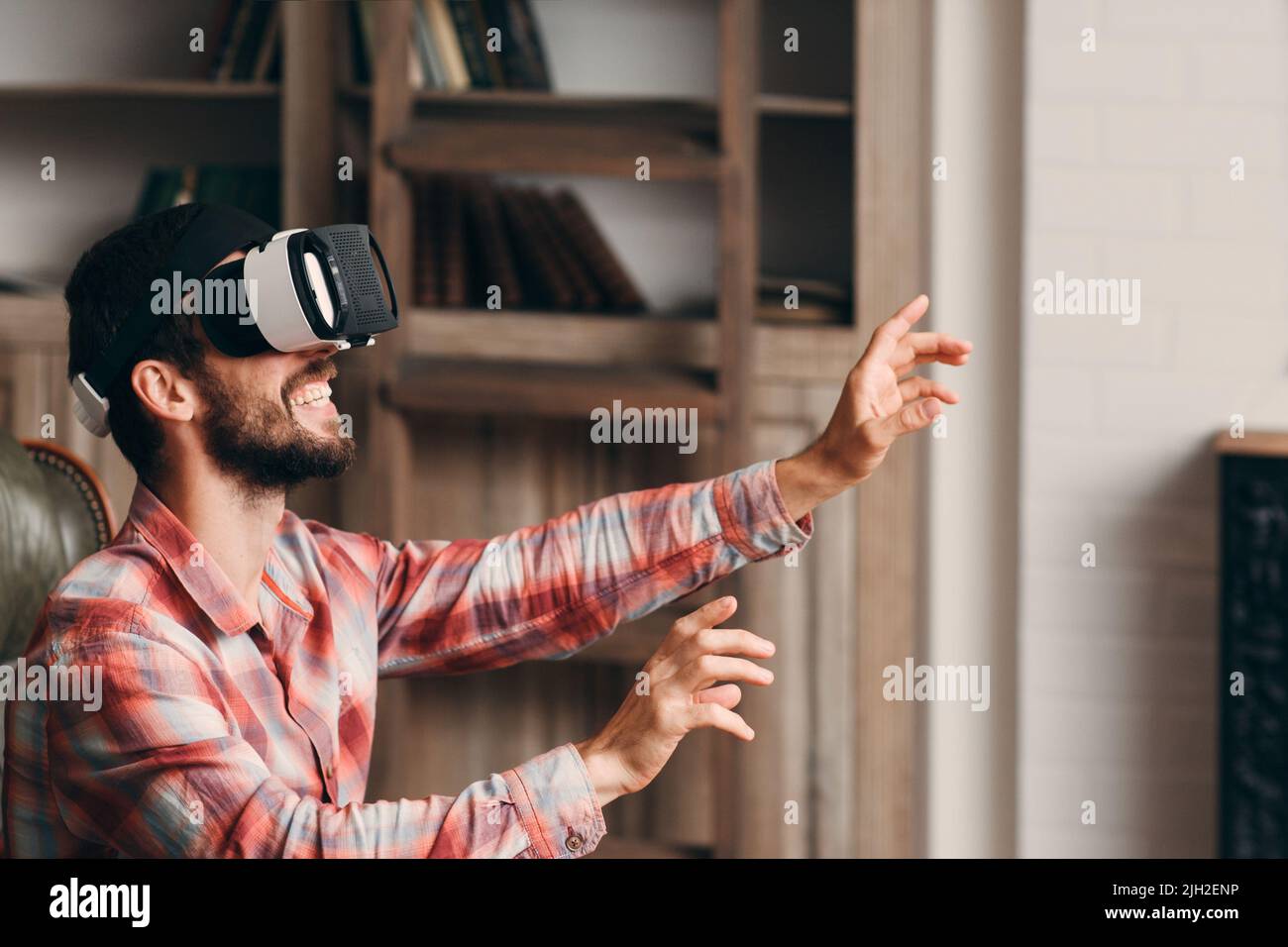 Happy bearded man using vr glasses Stock Photo