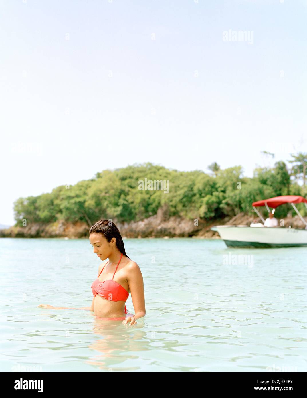 Woman wading in bay, Playa Rincon, Las Galeras, Dominican Republic Stock Photo