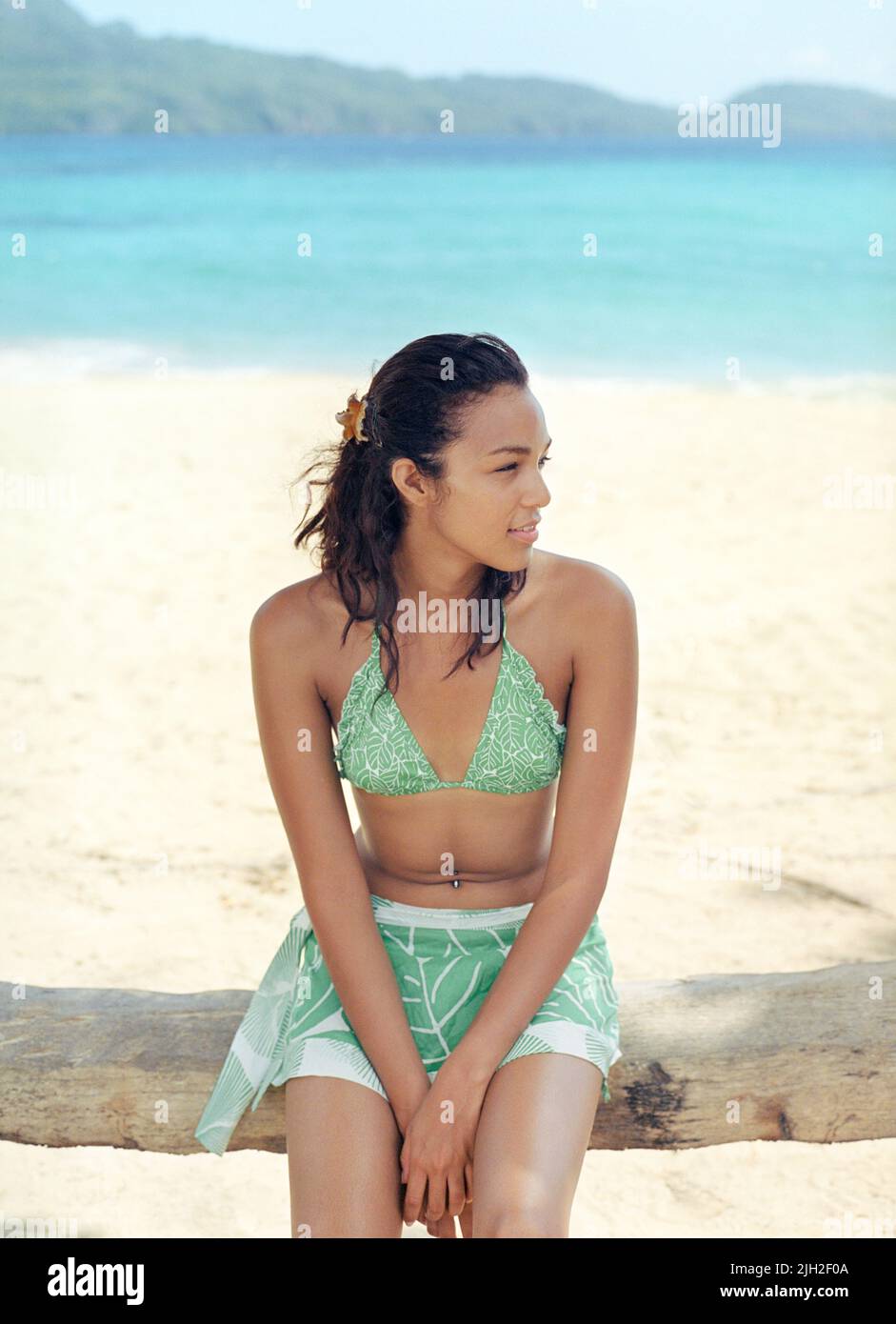 Woman sitting at Playa Rincon beach, Las Galeras, Dominican Republic Stock Photo