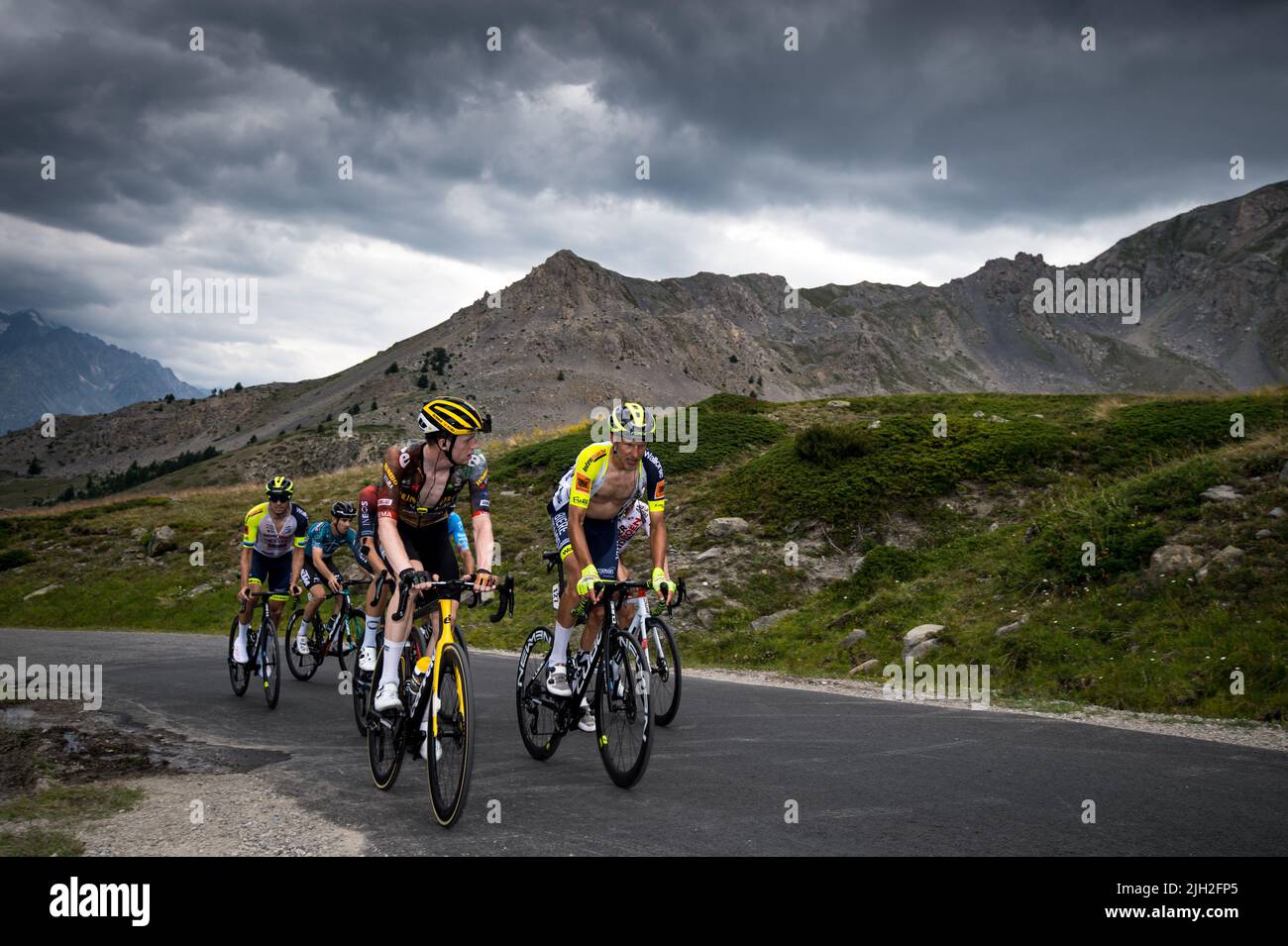 Belgian Nathan Van Hooydonck (Jumbo-Visma team) and Flemish Taco Van Der Hoorn (team Intermarché-Wanty Gobert Matériaux.) ahead a riders group in the last kilometers of the climb of the Col du Granon during the 11th stage of the Cycling Tour de France 2022. The 11th stage of the Tour de France 2022 between Albertville and the top of the Col du Granon with a distance of 151.7 km. The winner of the stage is the Danish Jonas Vingegaard (Jumbo Visma team) who also takes the first place in the general classification at the detriment of the Slovenian Tadej Pogacar (team UAE Emirates). Colombian Nair Stock Photo