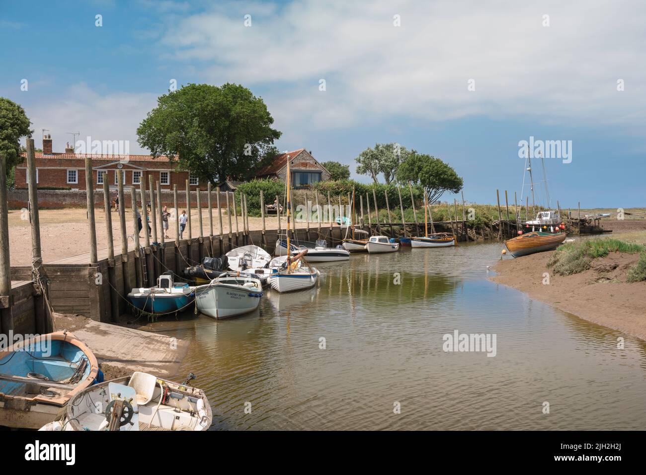 North Norfolk coast, view in summer of leisure boats moored in the River Glaven in the scenic seaside town of Blakeney, north Norfolk, England, UK Stock Photo