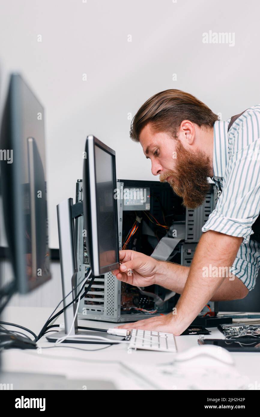 System administrator turn on computer monitor Stock Photo