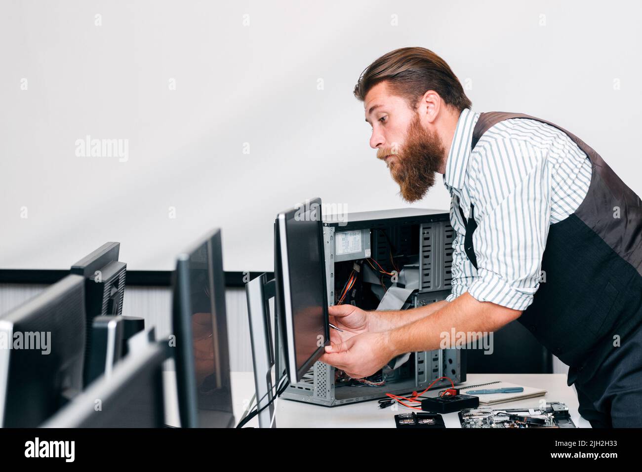 Programmer connecting monitor and CPU in office Stock Photo