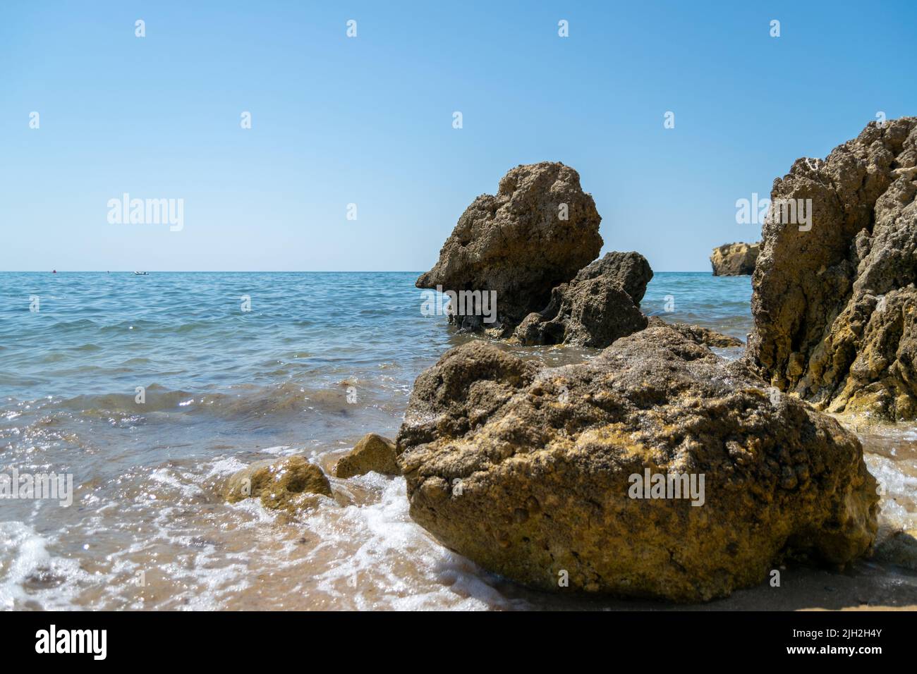 Ocean Beach and rocks landscape, zen views. Traveling along the coast. South Europe, Atlantic Ocean. Calm sea waters. Stock Photo