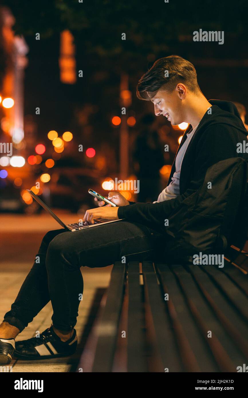 Young man work and communicate at night Stock Photo
