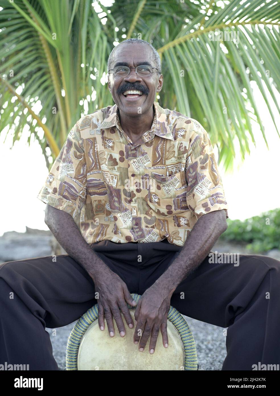 A Bele drummer plays by the beach. Fort de France, Martinique. French Caribbean. Stock Photo