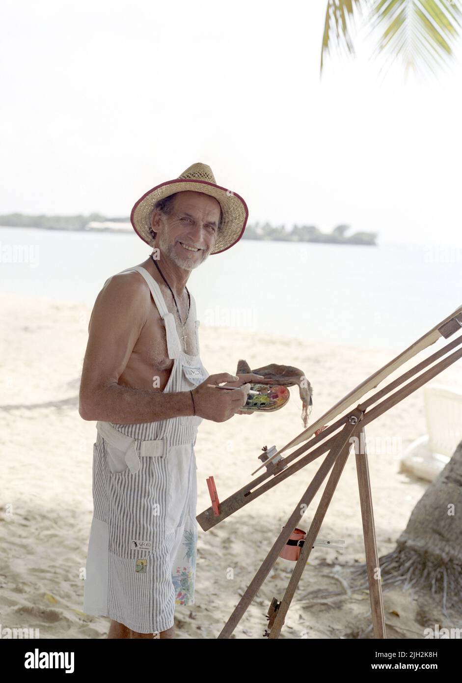 A French painter paints on the beach. Point de Salines , St. Anne’s beach. Southern Coast of Martinique. Stock Photo