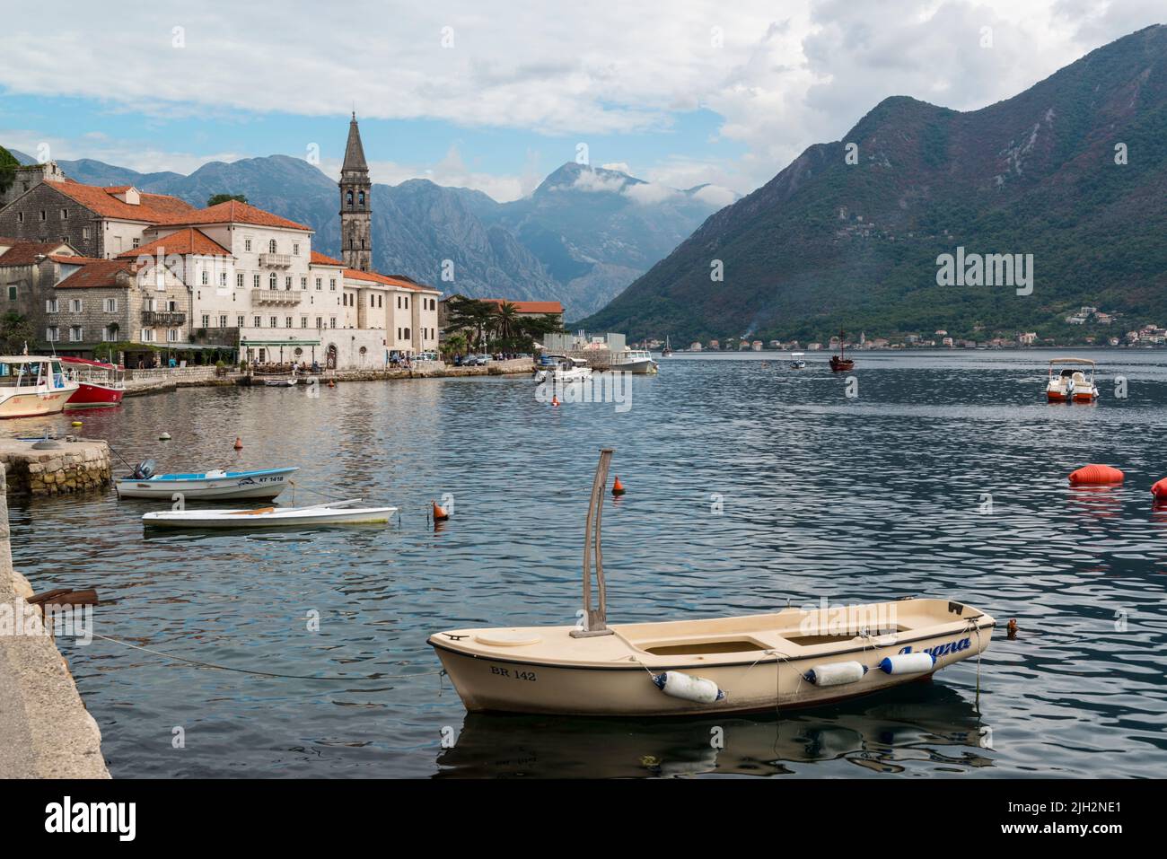 Waterfront of the old town Perast with some moored small boats at the Bay of Kotor, Montenegro. Stock Photo