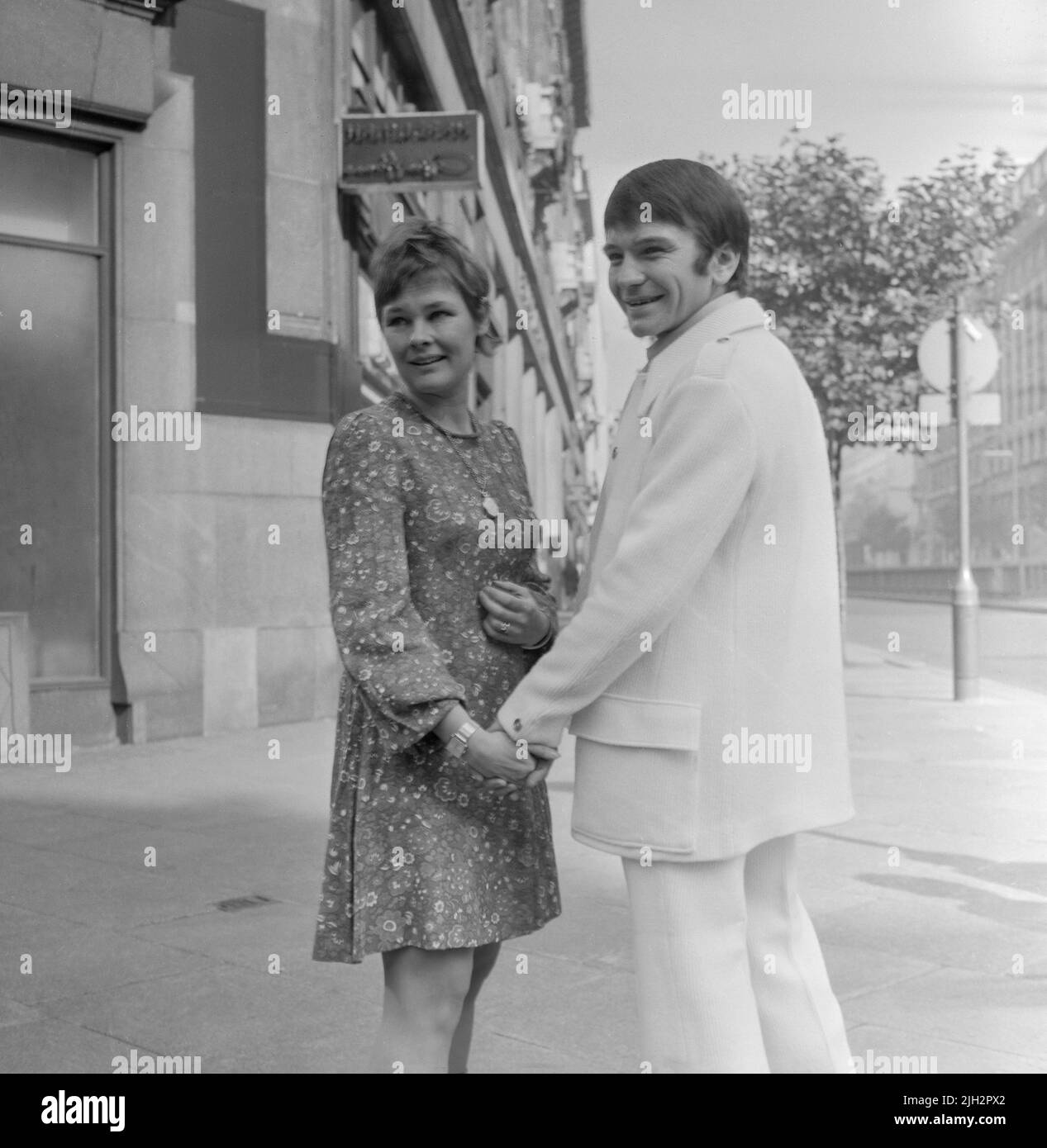English actress Judi Dench and her then fiancé the actor Michael Williams, pose for the camera, after their engagement, in London in 1970. Stock Photo
