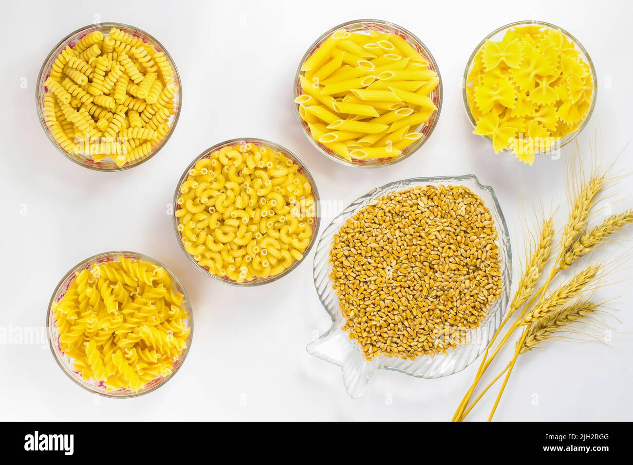 Five types of pasta in glass plates. Grains of wheat and wheat