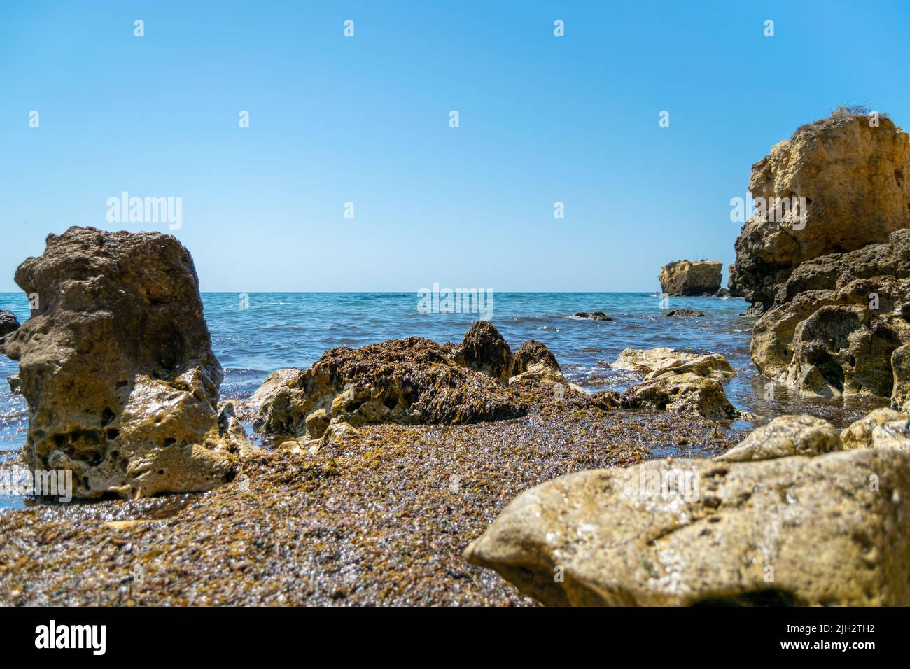 Ocean Beach and rocks landscape, zen views. Traveling along the coast. South Europe, Atlantic Ocean. Calm sea waters. Stock Photo