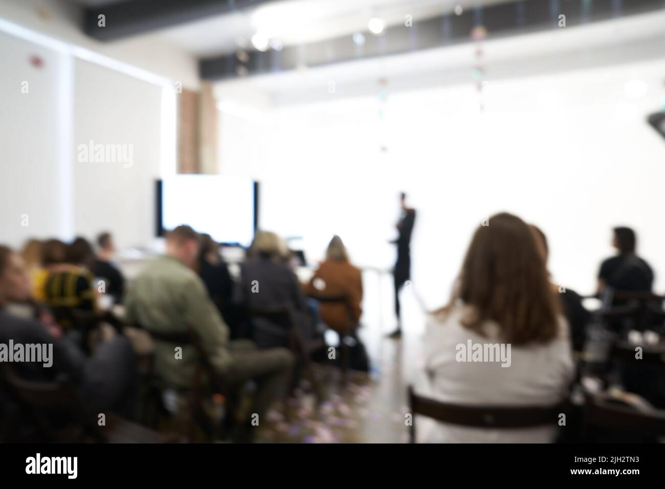 Blurred background of the business conference, one man on the stage, presentation of the project, public talk. High quality photo Stock Photo