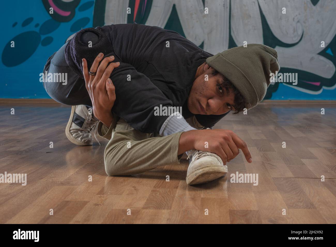 Modern rapper dancing in garage. Urban lifestyle, hip hop Stock Photo ...