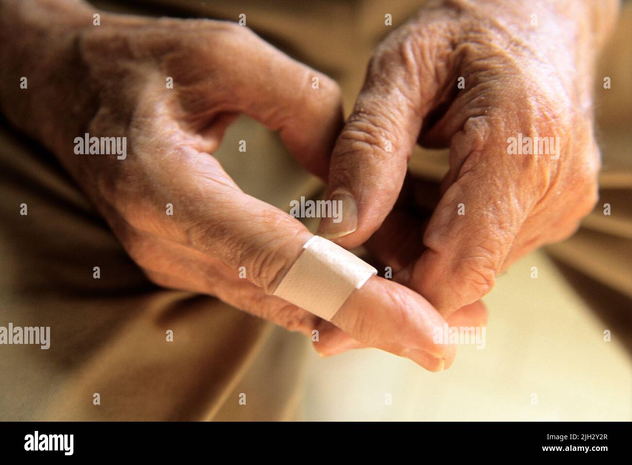 Man putting a band-aid on his finger. Dressing an injury at home Stock Photo