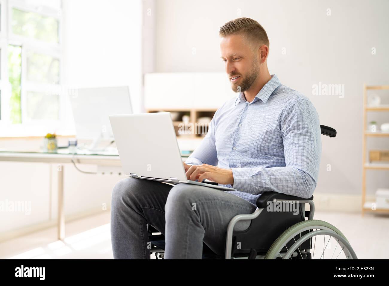 Young Worker With Disability In Wheel Chair Stock Photo