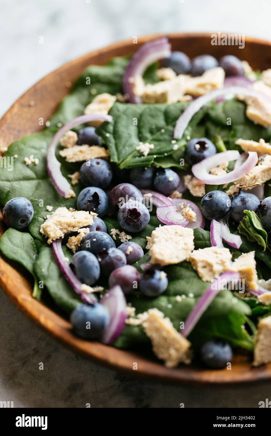 New Zealand Spinach with Blueberries and Vegan Feta Stock Photo