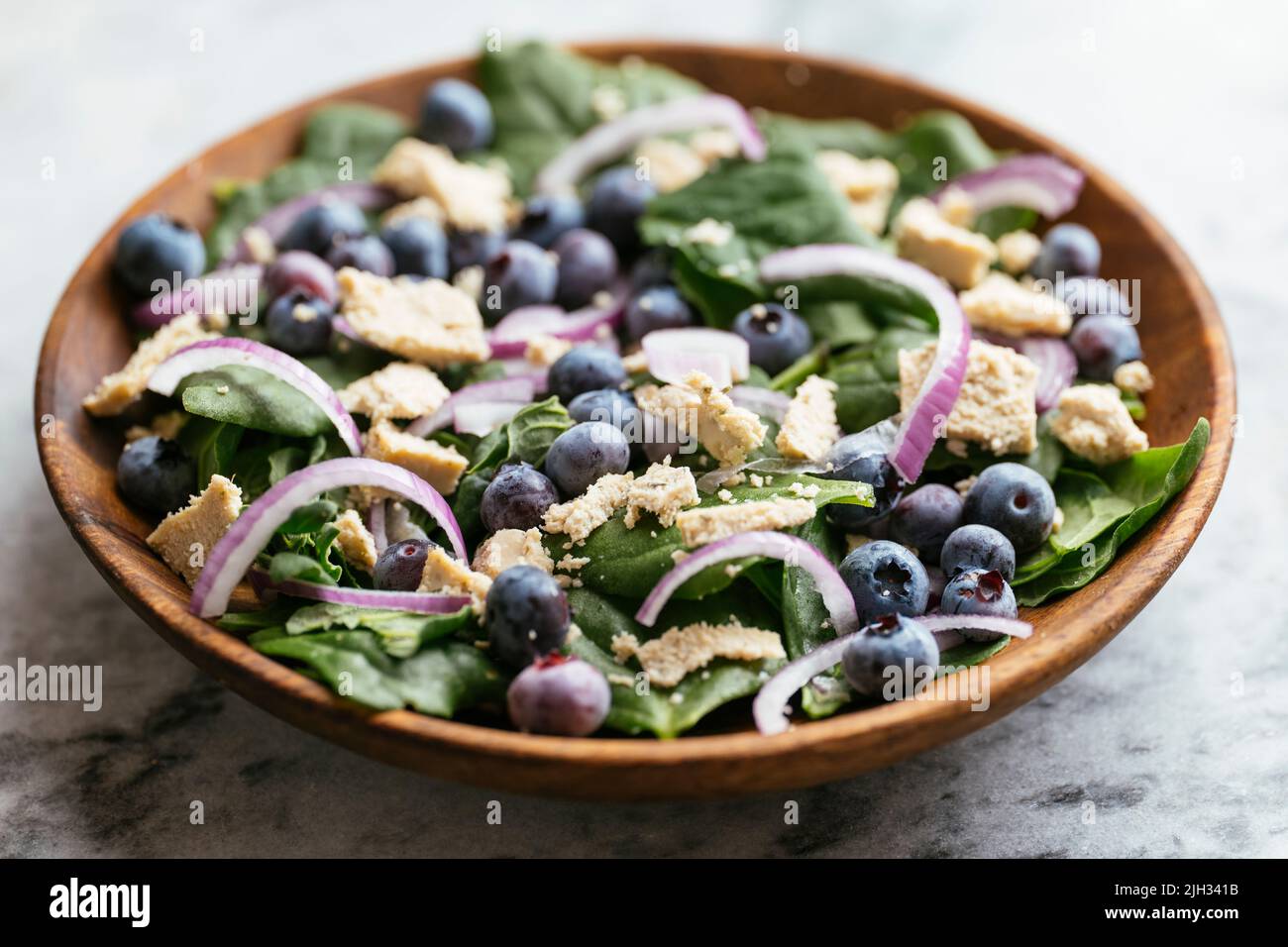 New Zealand Spinach with Blueberries and Vegan Feta Stock Photo