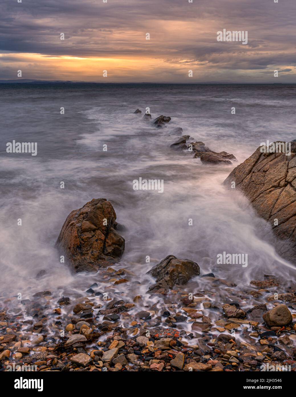 First light on the rocks at St Monans on the east coast of Scotland Stock Photo