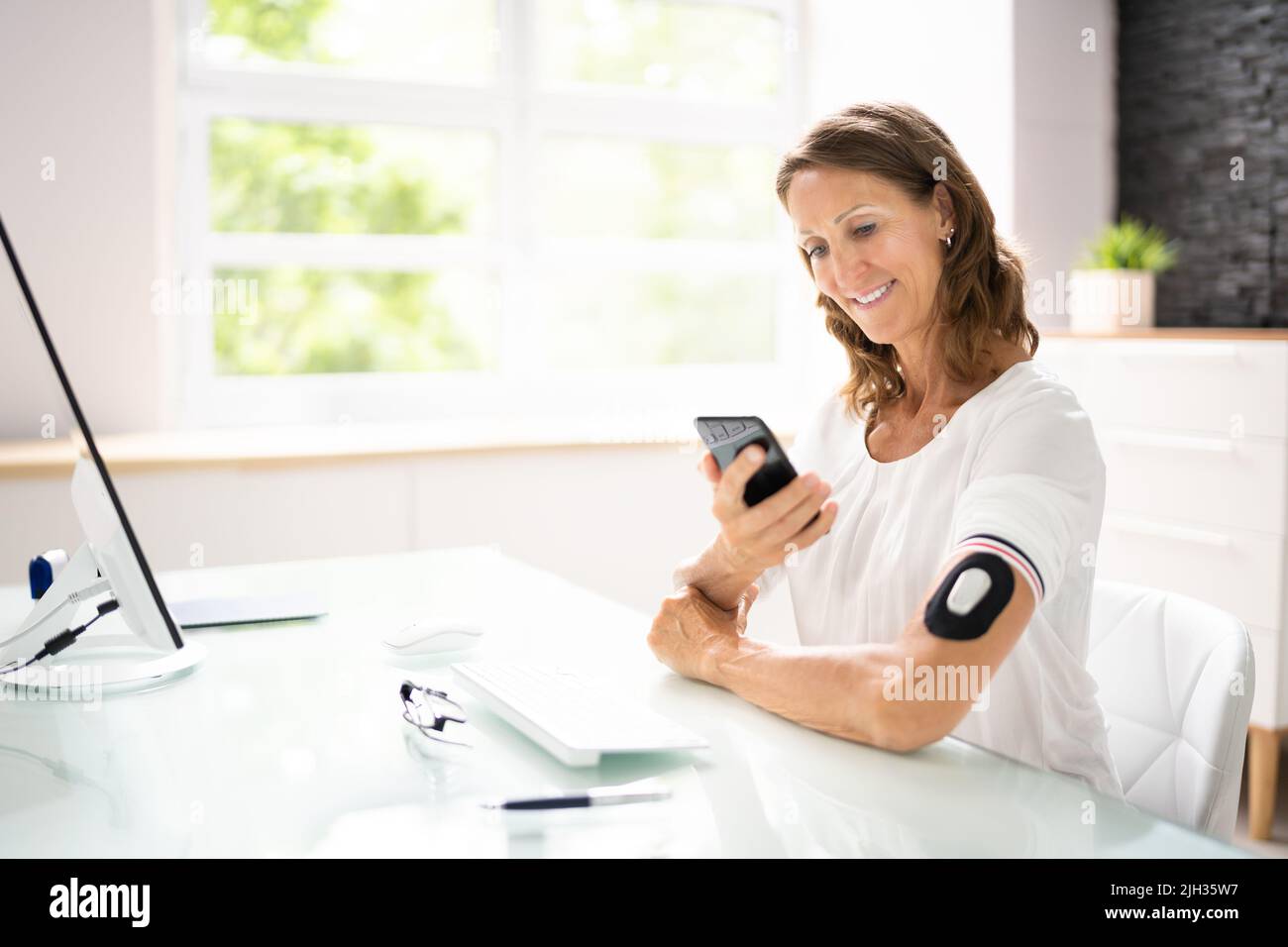 Continuous Glucose Blood Check Using Smartphone. Patient With Diabetes