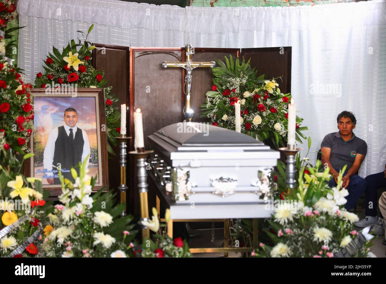 Narciso Lopez, father of late migrant Jose Lopez, 34, sits next to the coffin of his son during his wake after being repatriated from San Antonio, Texas, U.S., at his family's home in Celaya, in Guanajuato state, Mexico July 14, 2022. REUTERS/Edgard Garrido Stock Photo