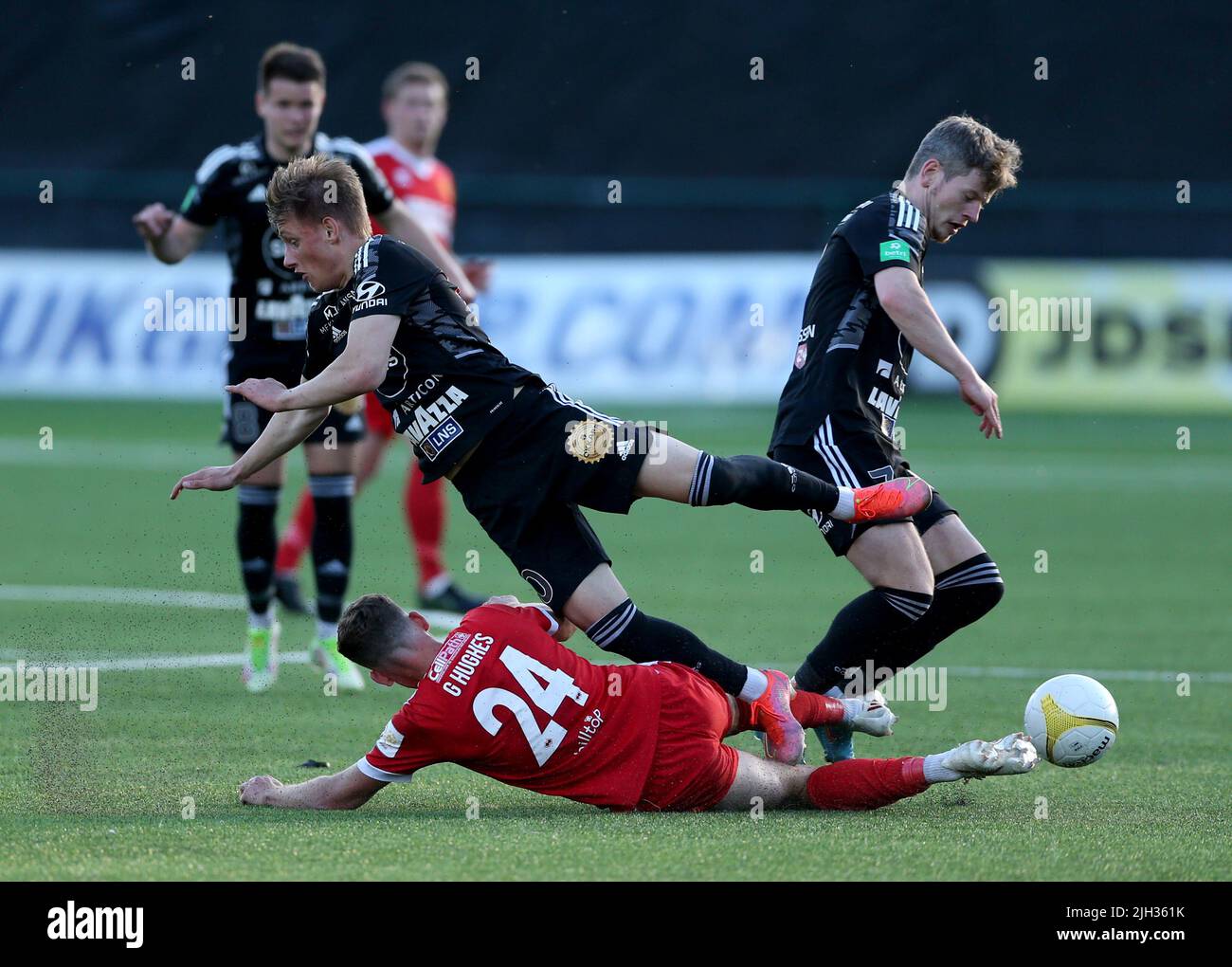 Newton’s George Hughes makes a tackle on Torshavn’s Aki Debes Samuelsen during the UEFA Europa Conference League First Qualifying Round second leg match at Park Hall, Oswestry. Picture date: Thursday July 14, 2022. Stock Photo