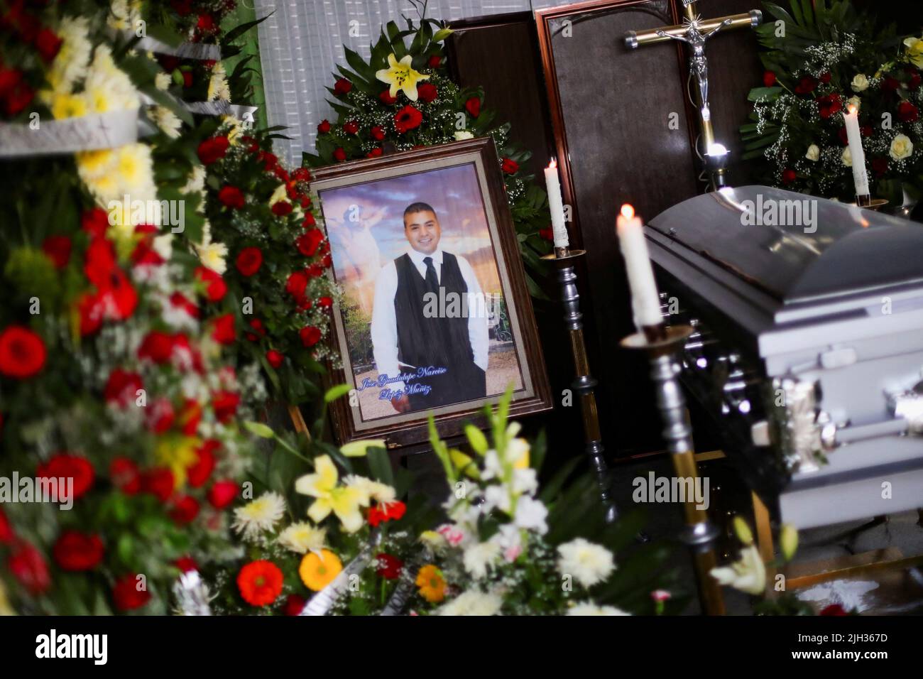 A framed photo of late migrant Jose Lopez, 34, is placed next to his coffin during his wake after being repatriated from San Antonio, Texas, U.S., at his family's home in Celaya, in Guanajuato state, Mexico July 14, 2022. REUTERS/Edgard Garrido Stock Photo