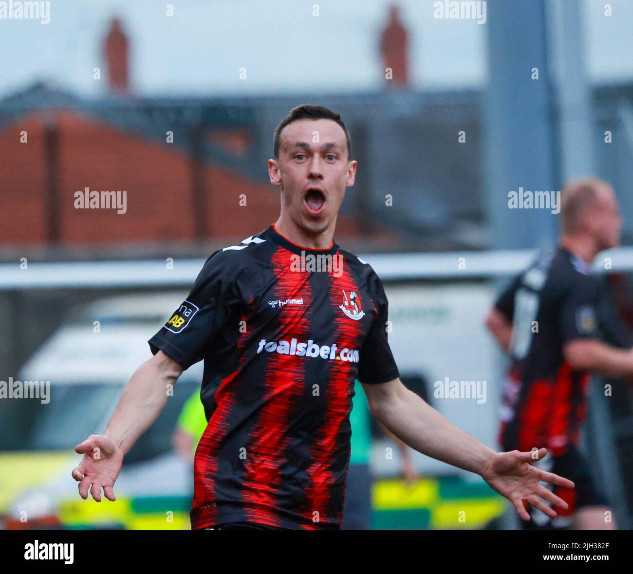Seaview, Belfast, Northern Ireland, UK. 14 July 2022. UEFA Conference League First Qualifying Round  (second leg) – Crusaders v Magpies. Action from tonight's game at Seaview (Crusaders in red/black). Paul Heatley (22) scoring and celebrating the opening goal. Credit: CAZIMB/Alamy Live News. Stock Photo