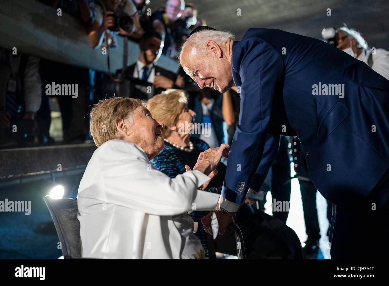 Jerusalem, Israel. 14th July, 2022. U.S President Joe Biden, speaks with Holocaust survivors Rena Quint, left, and Giselle Cycowicz, right, during a visit to the Hall of Remembrance of the Yad Vashem Holocaust Memorial Museum, July 14, 2022 in Jerusalem, Israel. Credit: Adam Schultz/White House Photo/Alamy Live News Stock Photo