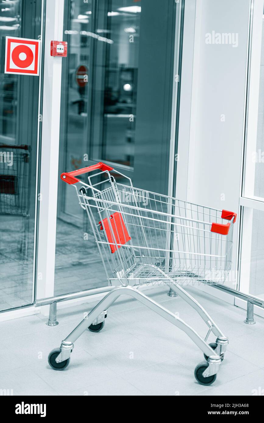lone shopping trolley in supermarket Stock Photo
