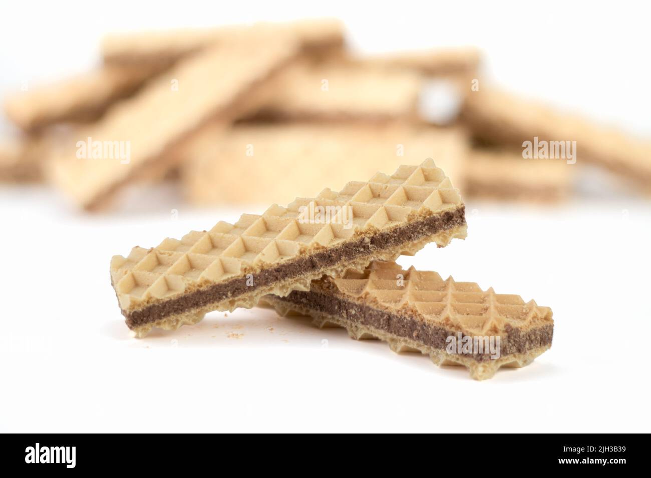 Delicious chocolate wafer on bright background. Close up view. Selective focus. Stock Photo