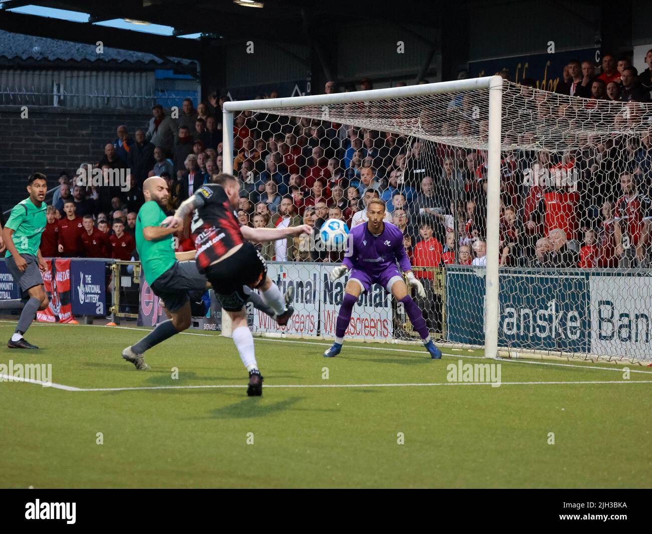Seaview, Belfast, Northern Ireland, UK. 14 July 2022. UEFA Conference League First Qualifying Round  (second leg) – Crusaders v Magpies. Action from tonight's game at Seaview (Crusaders in red/black). Credit: Crusaders captain Billy Joe Burns (2) scoring and celebrating the winning goal. CAZIMB/Alamy Live News. Stock Photo