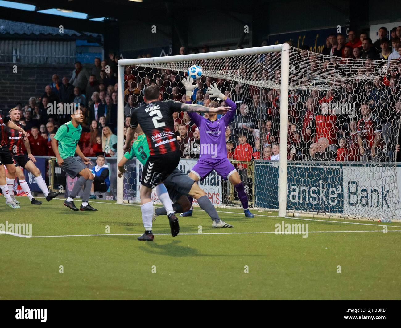 Seaview, Belfast, Northern Ireland, UK. 14 July 2022. UEFA Conference League First Qualifying Round  (second leg) – Crusaders v Magpies. Action from tonight's game at Seaview (Crusaders in red/black). Credit: Crusaders captain Billy Joe Burns (2) scoring and celebrating the winning goal. CAZIMB/Alamy Live News. Stock Photo