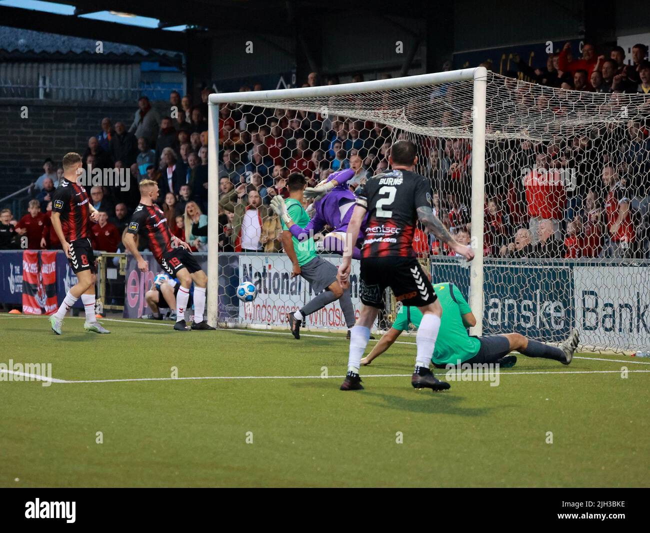 Seaview, Belfast, Northern Ireland, UK. 14 July 2022. UEFA Conference League First Qualifying Round  (second leg) – Crusaders v Magpies. Action from tonight's game at Seaview (Crusaders in red/black). Credit: Crusaders captain Billy Joe Burns (2) scoring and celebrating the winning goal. CAZIMB/Alamy Live News. Stock Photo