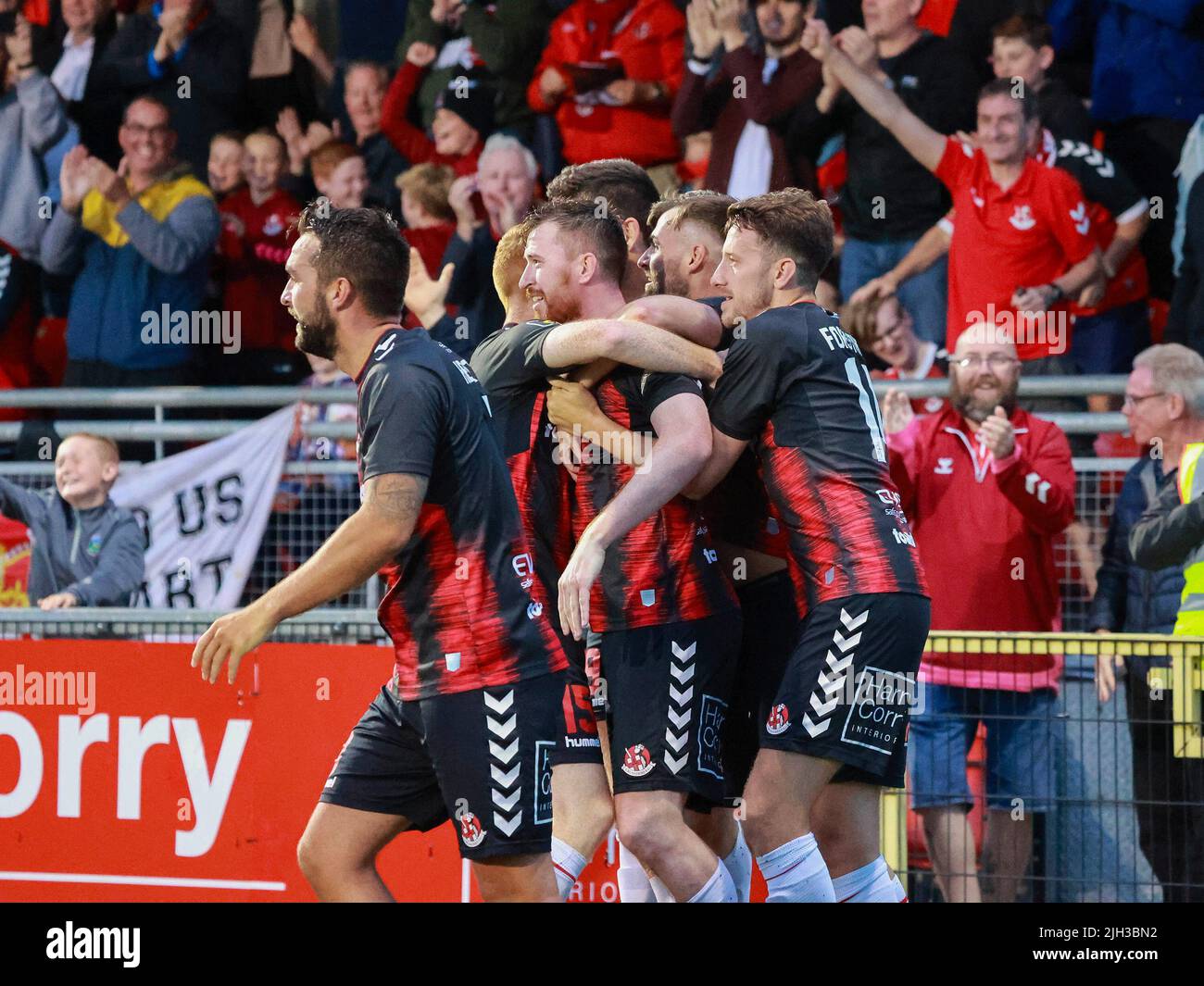 Seaview, Belfast, Northern Ireland, UK. 14 July 2022. UEFA Conference League First Qualifying Round  (second leg) – Crusaders v Magpies. Action from tonight's game at Seaview (Crusaders in red/black). Credit: Crusaders captain Billy Joe Burns (2) scoring and celebrating the winning goal. CAZIMB/Alamy Live News. Stock Photo