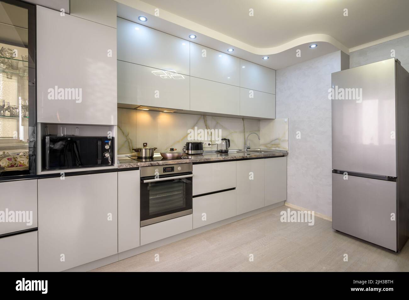 Interior of modern trendy white kitchen Stock Photo - Alamy