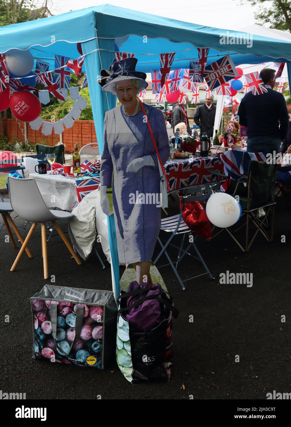 Cardboard cut-out of Queen Elizabeth II by Table Decorated with bunting At Street Party Celebrating Queen Elizabeth II Platinum Jubilee Surrey England Stock Photo