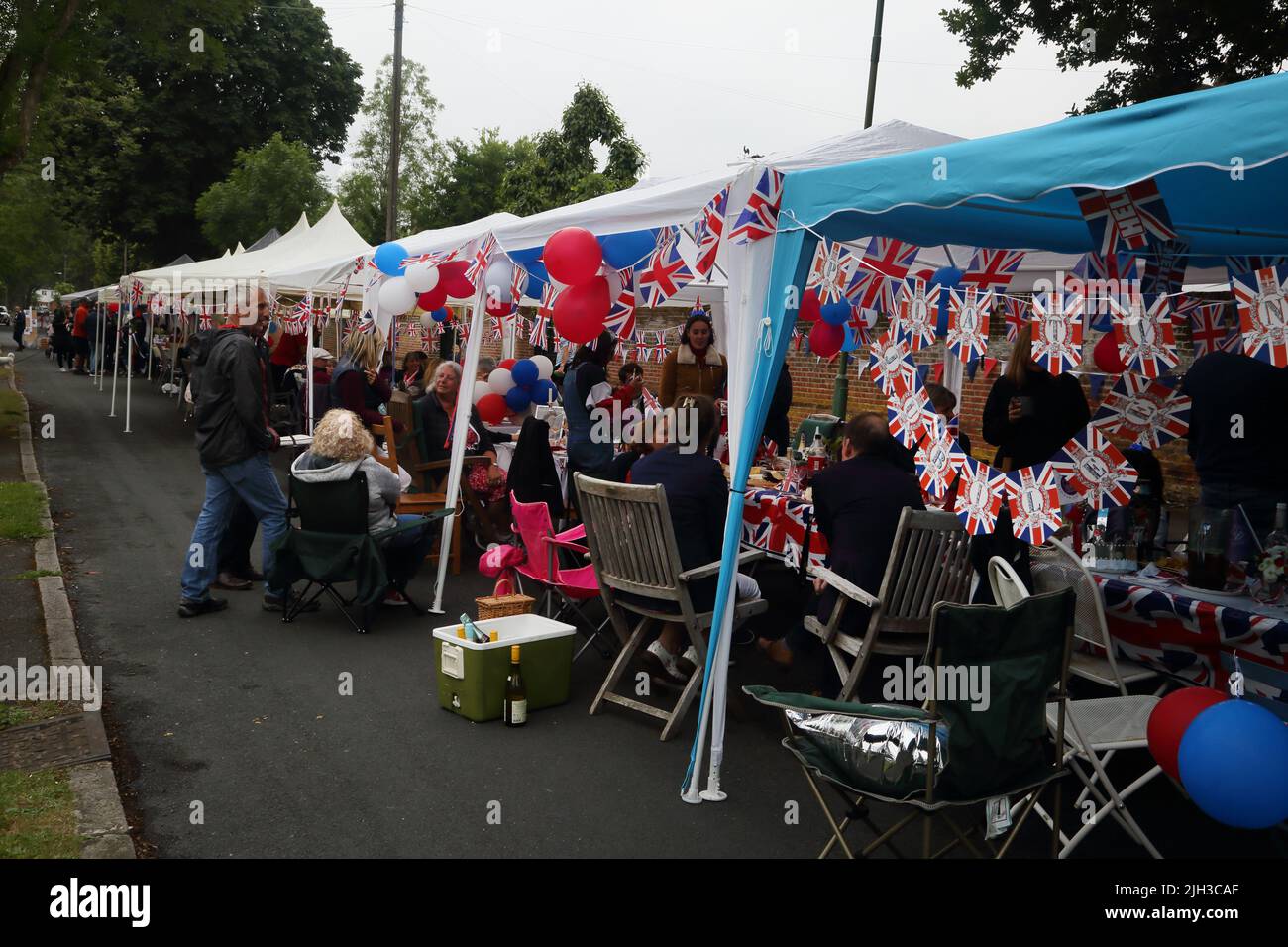 People Eating and Drinking at Street Party Celebrating Queen Elizabeth II Platinum Jubilee Surrey England Stock Photo