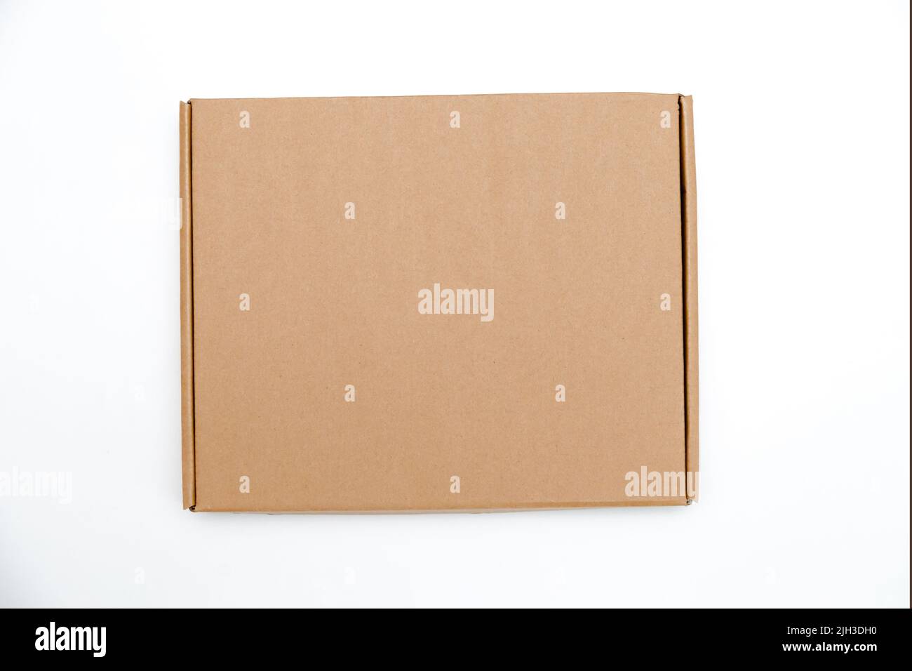 low cardboard box with hinged lid isolated on white background