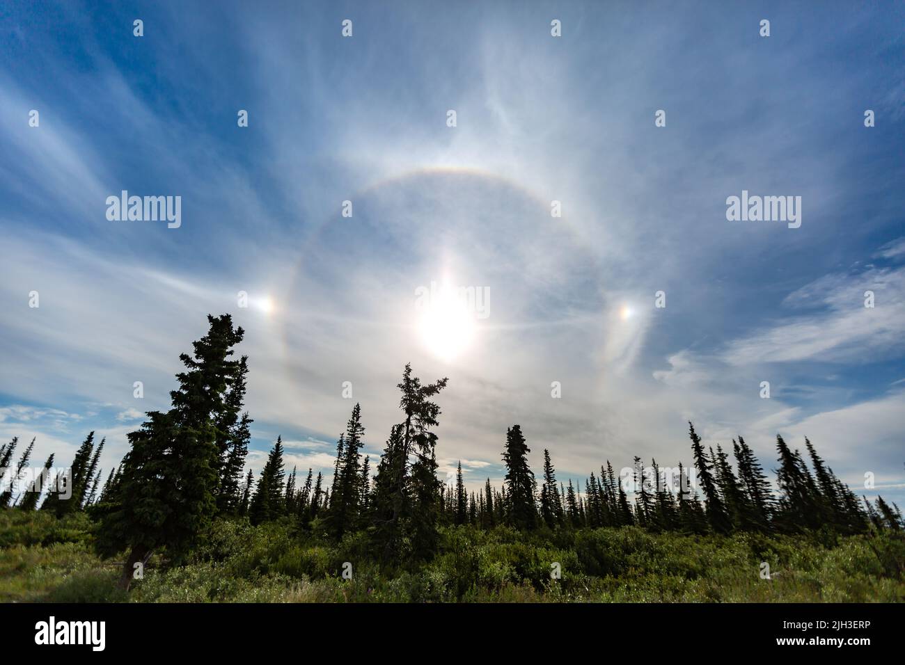 Summer sun dog (parhelion) in the sky, near Deline, Northwest Territories, Canada. Stock Photo