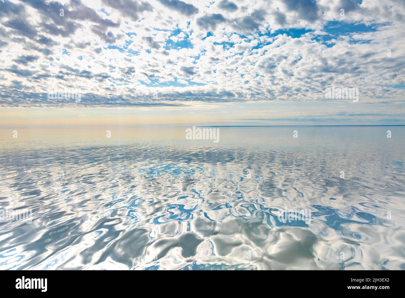 Heavenly reflection of clouds on Great Bear Lake, Northwest Territories - the largest lake entirely in Canada, the ninth-largest in the world. Stock Photo