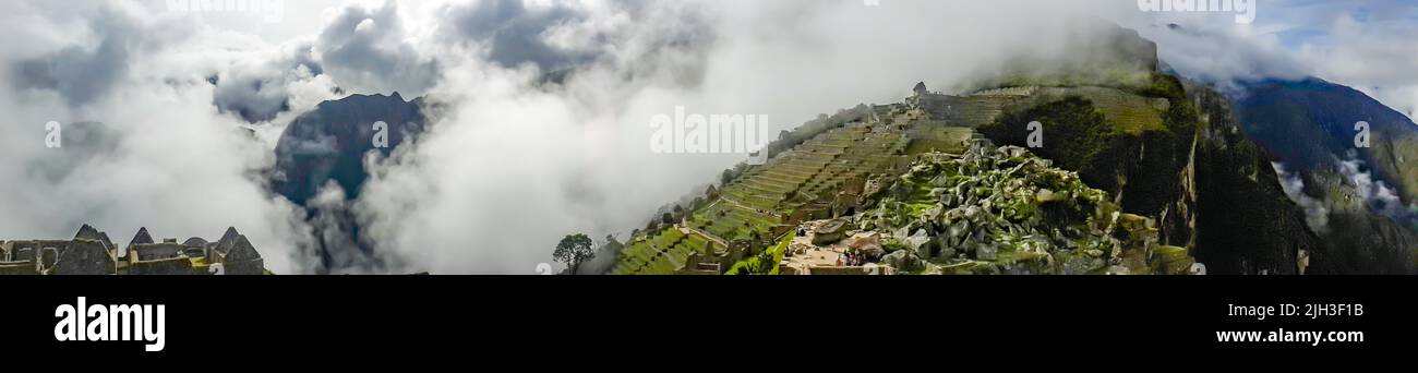 Panoramic view of Machu Piccu on cloudy day early. High angle view. Natural and historical background with copy space.Machu Picchu is an Incan citadel Stock Photo
