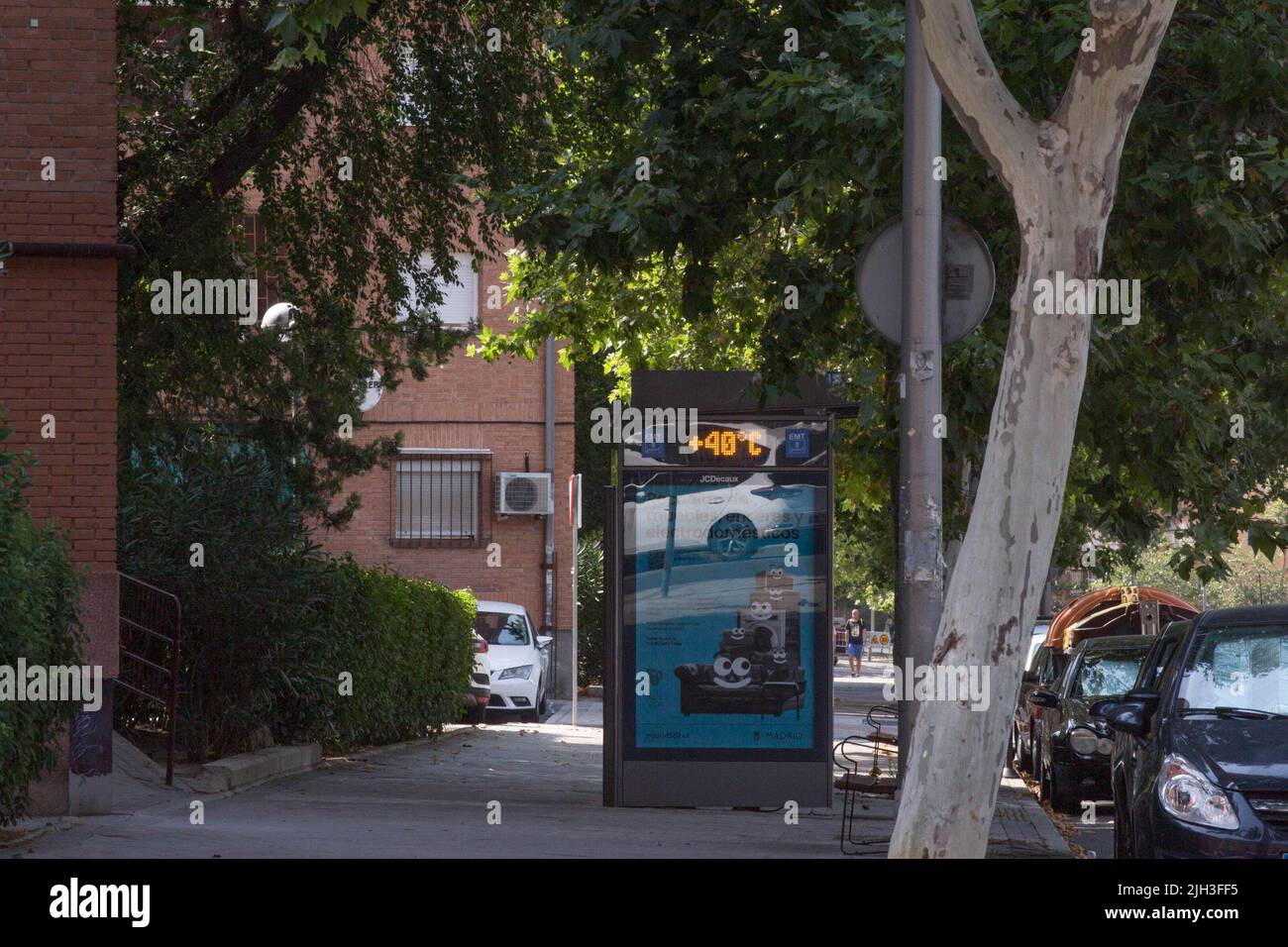 At a bus stop, the thermometer shows 40 degrees Celsius on the street in Madrid. A second heat wave in the summer affects the entire Iberian Peninsula, according to the alert from the State Meteorological Agency (AEMET), a drop in temperatures is expected next Monday, July 18, 2022. The Community of Madrid maintains the orange level for highs of 40-41 degrees Celsius. Stock Photo
