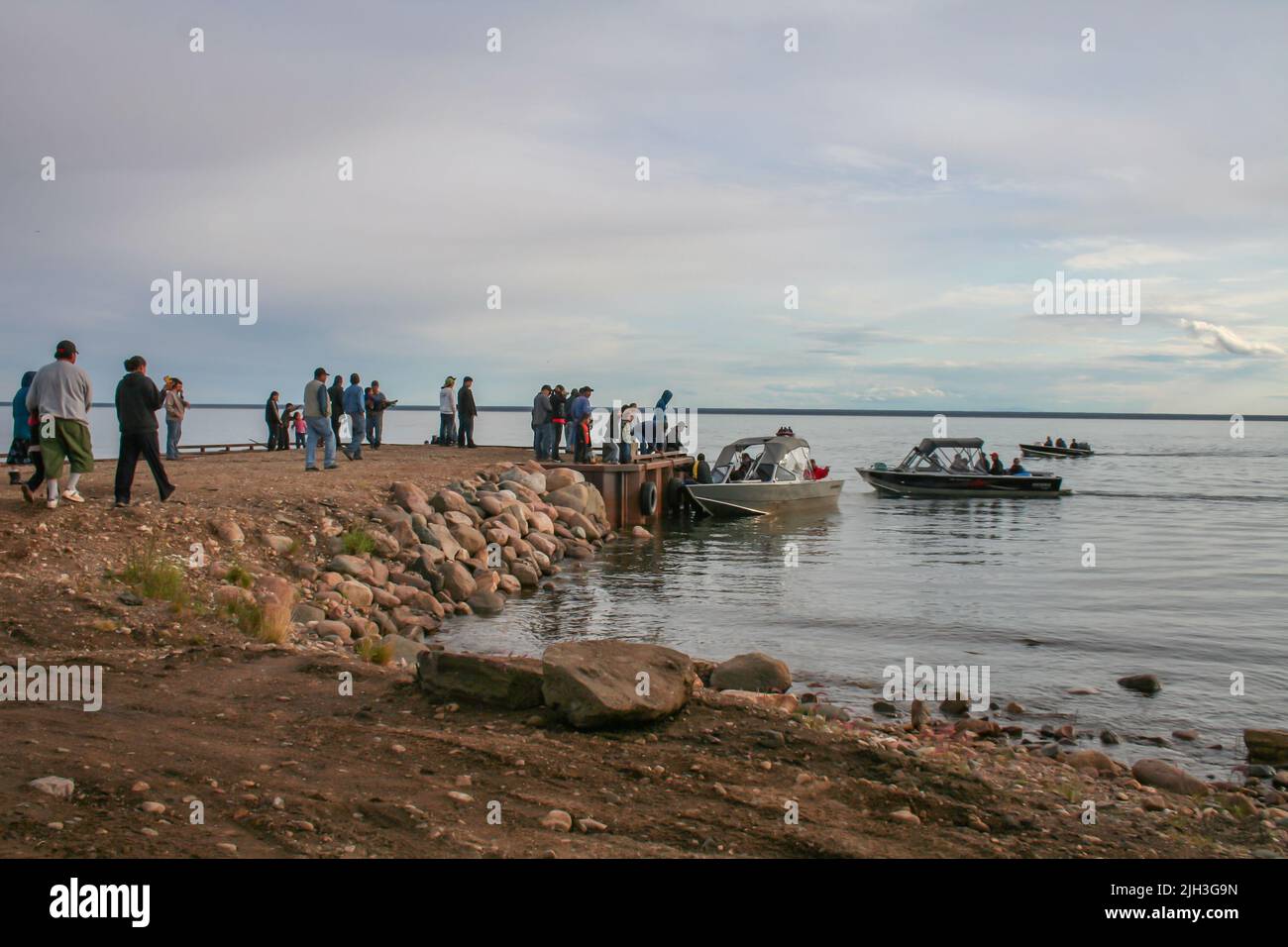 Arrival of Indigenous Dene visitors in boats on Great Bear Lake, in the northern community of Deline, Northwest Territories, Canada Stock Photo