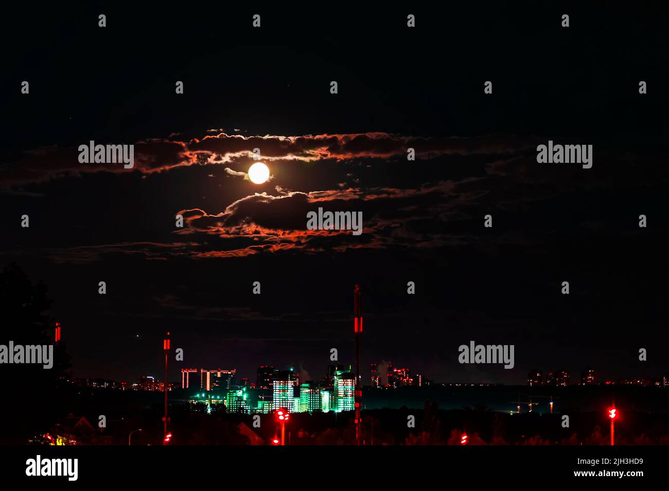 Urban city by dark night on full moon background, urban lights and ...