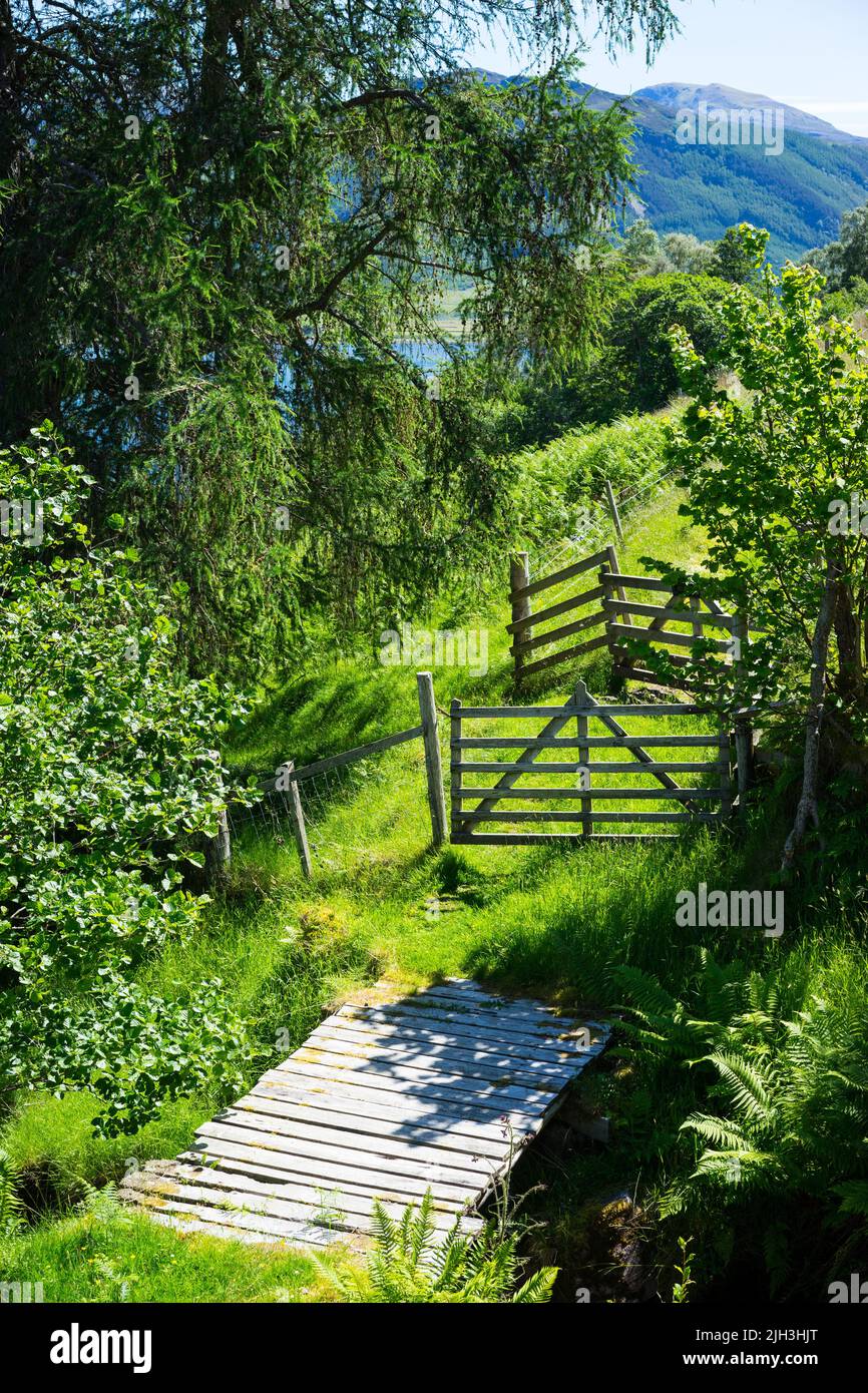 Double wooden gates and small wooden bridge at Letters, Scottish Highlands, UK. Stock Photo