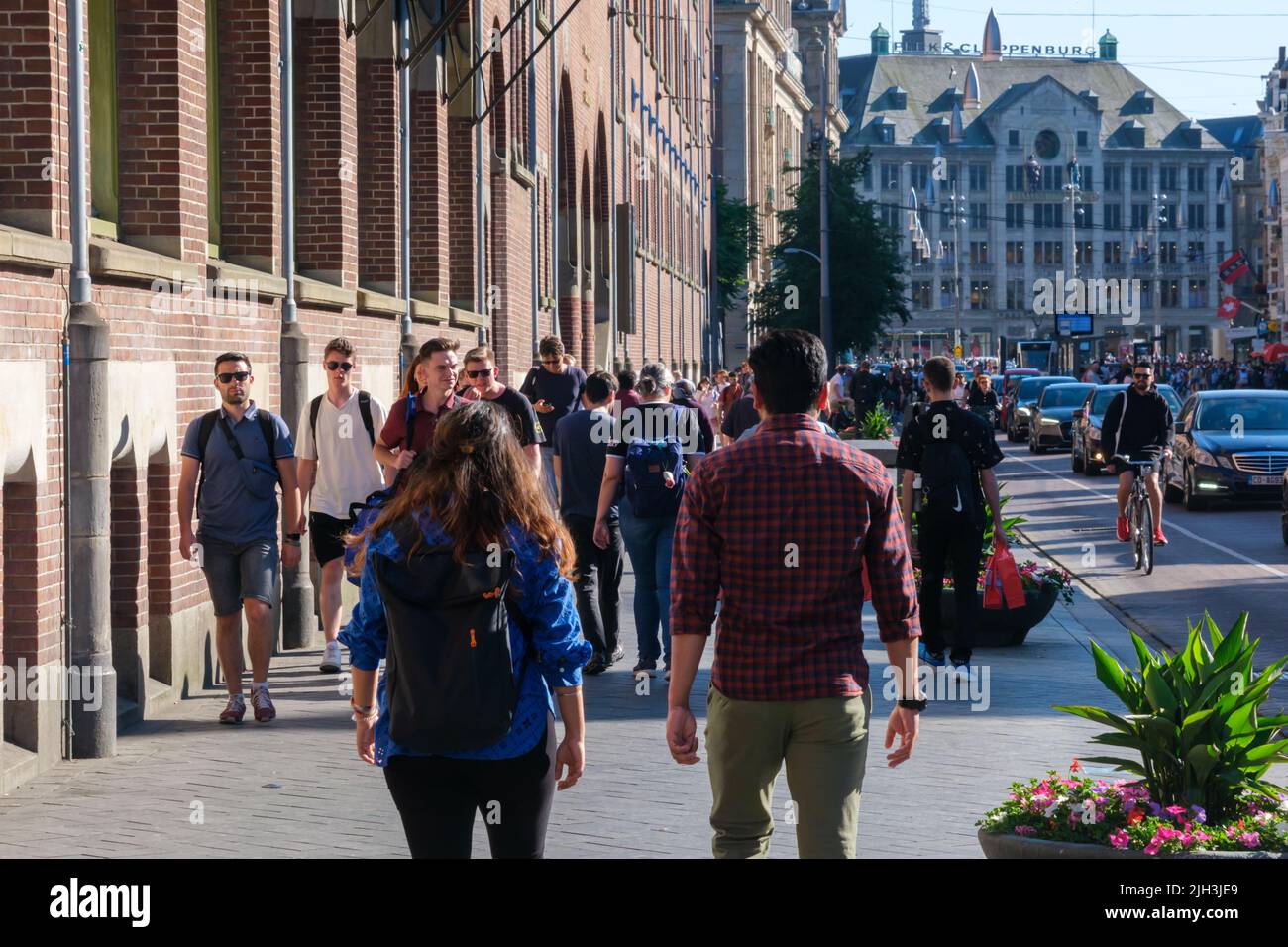 Amsterdam, The Netherlands - 22 June 2022: People walking on narrow street with many stores Stock Photo