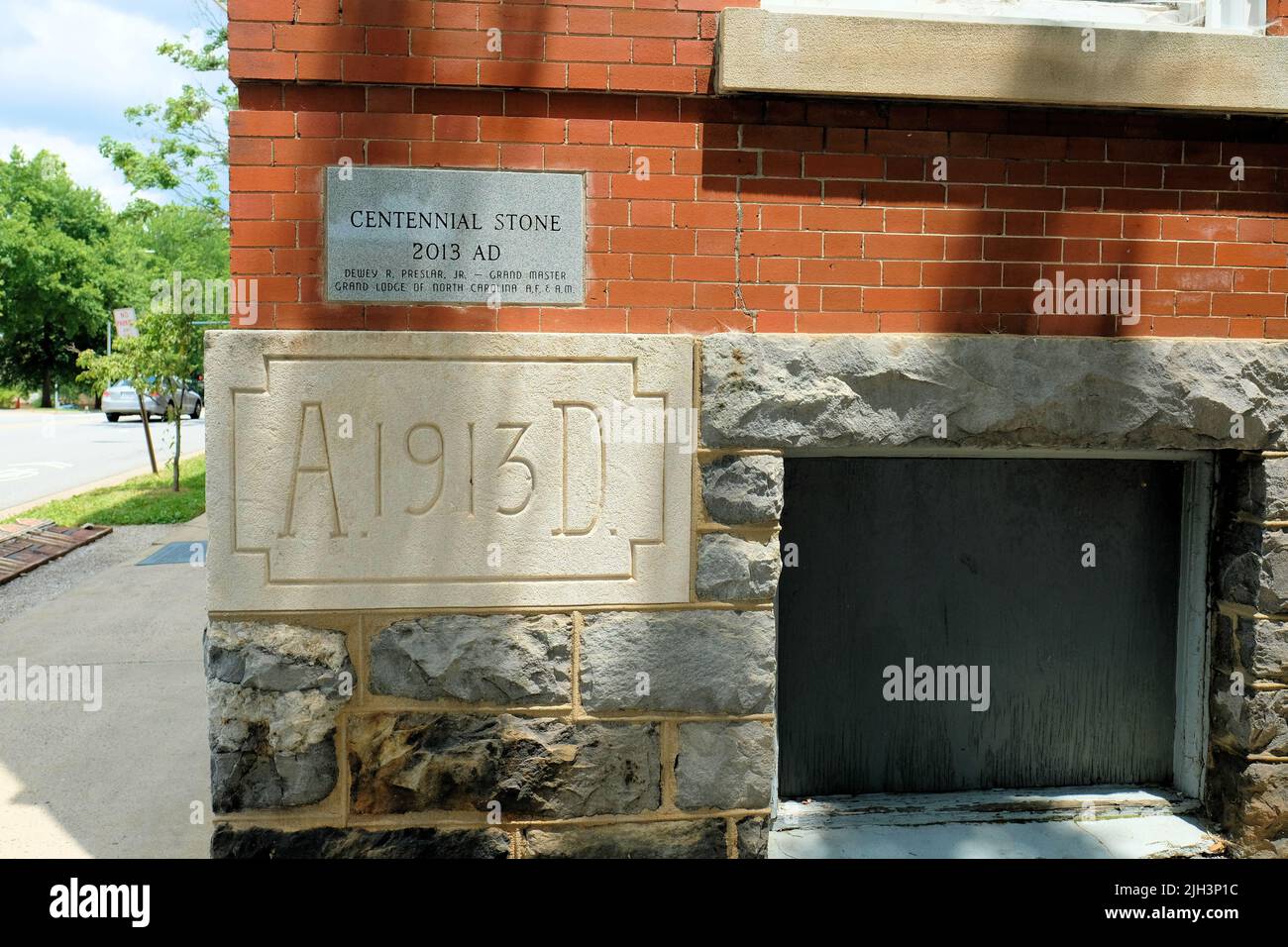 The original 3200 lb. cornerstone for the Asheville Masonic Temple laid in 1913 below the Centennial Stone placed in 2013; Asheville, North Carolina. Stock Photo