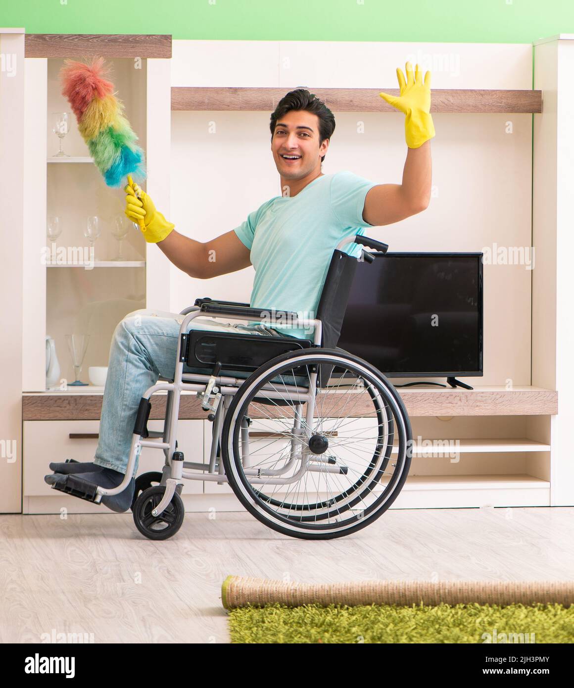 The disabled man on wheelchair cleaning house Stock Photo Alamy
