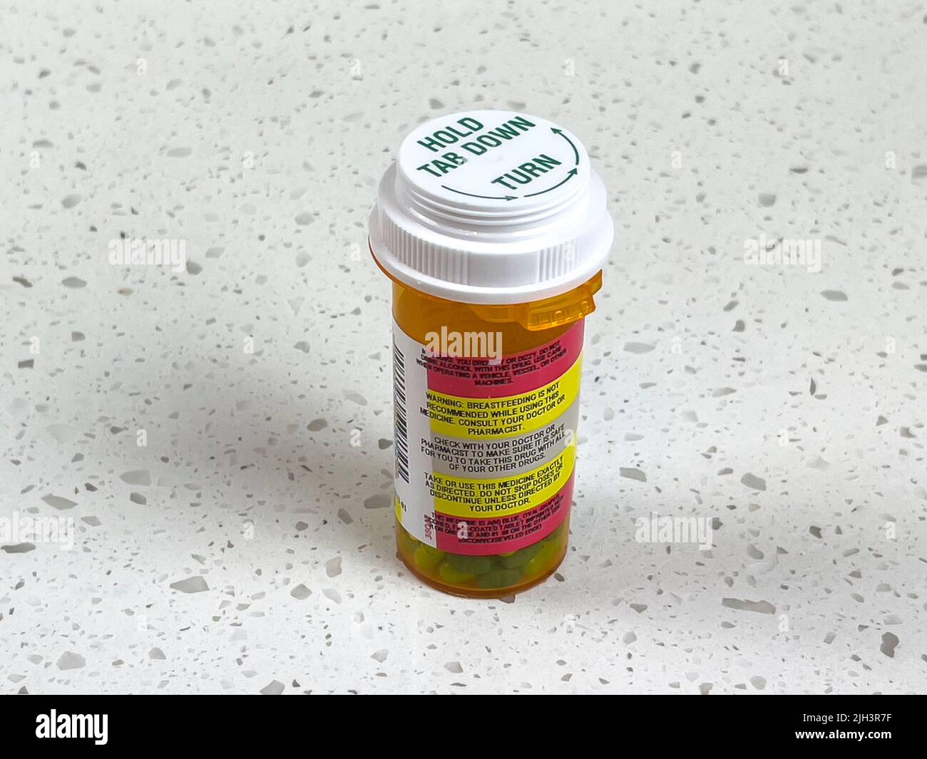 Angled view of the warning labels on the side of a prescription pill bottle Stock Photo