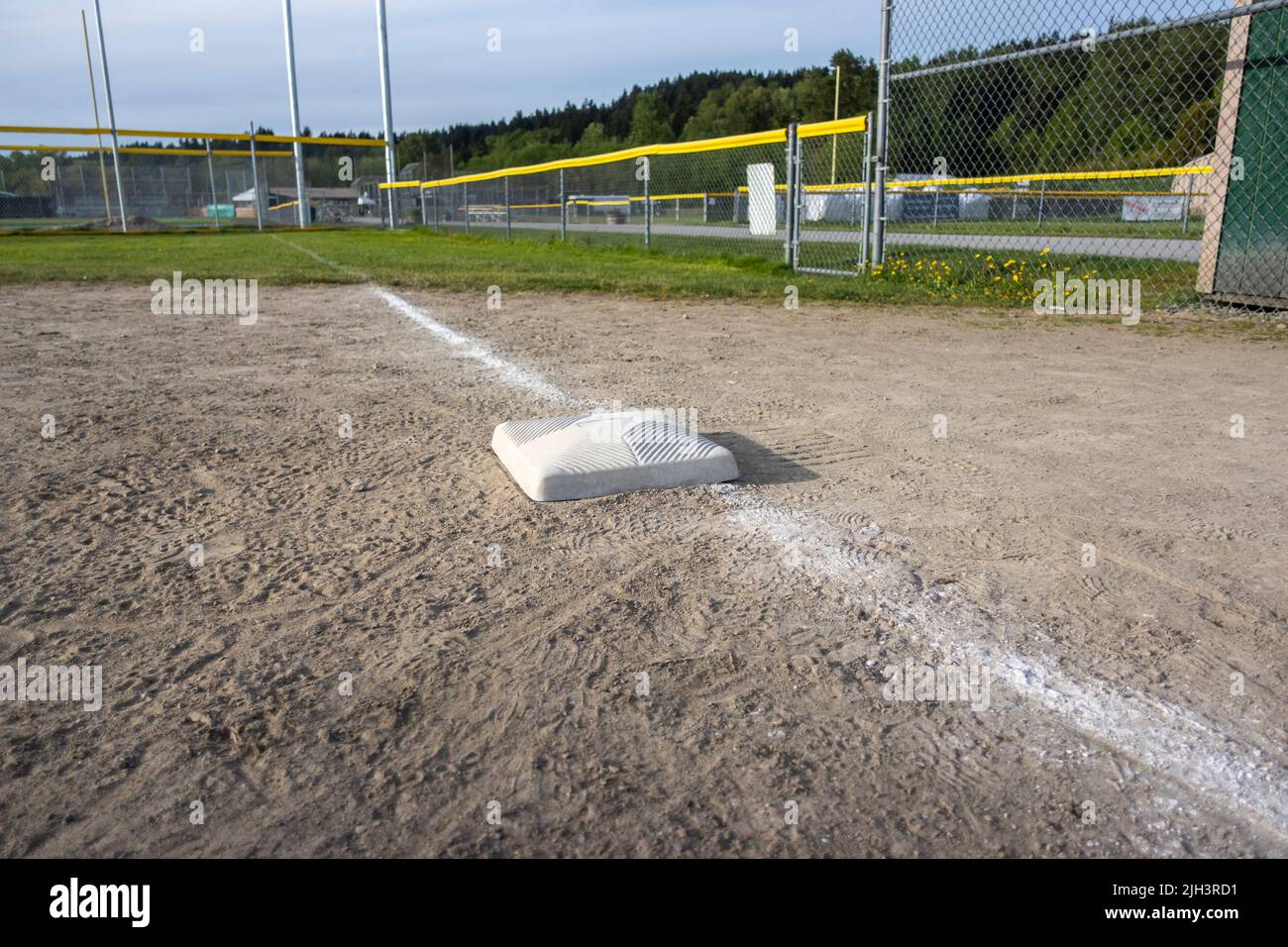 close up view of a base on a clean baseball field on a bright, sunny day Stock Photo